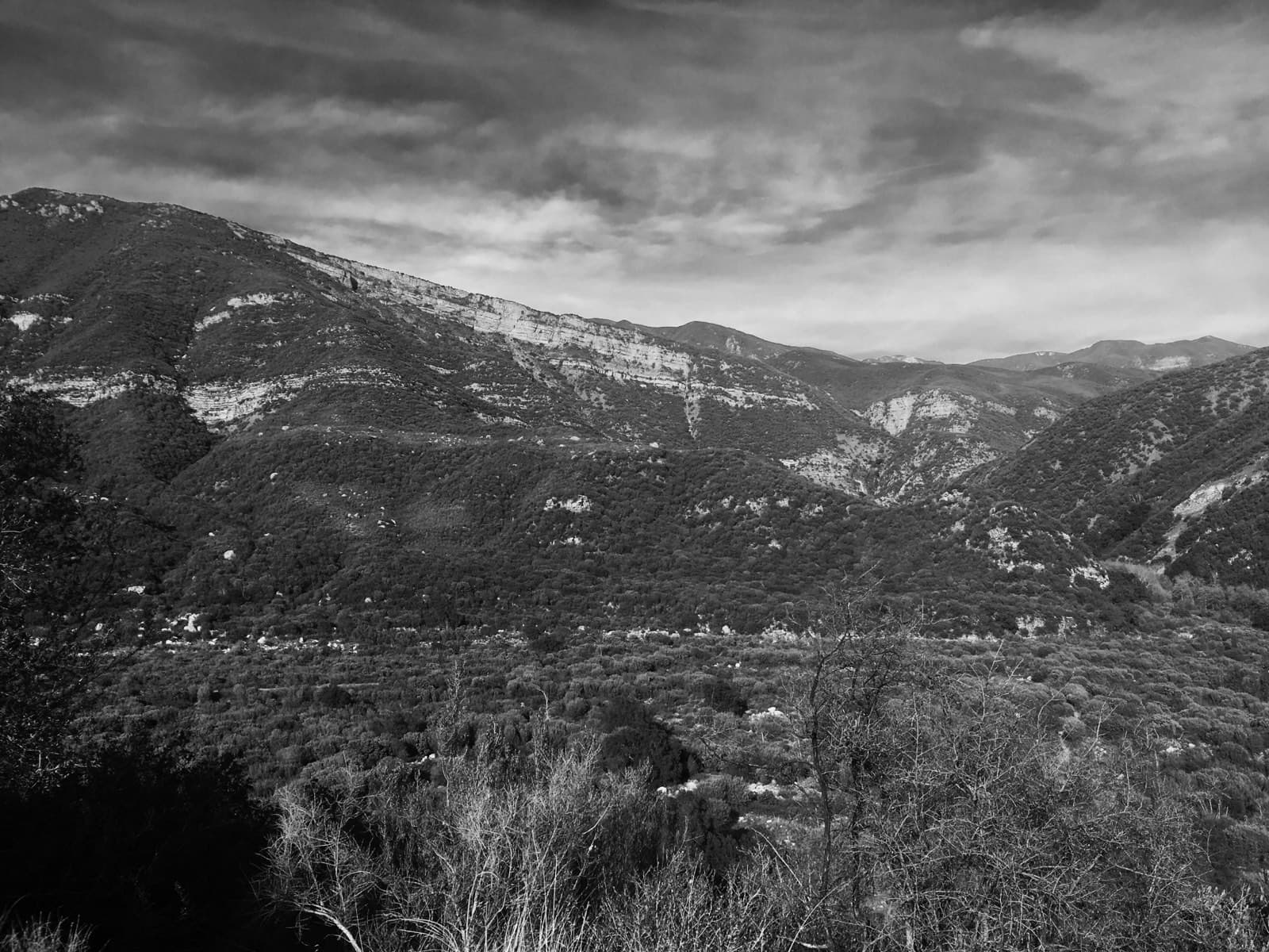 Black-and-white ridge line with cloud shadow across the slopes